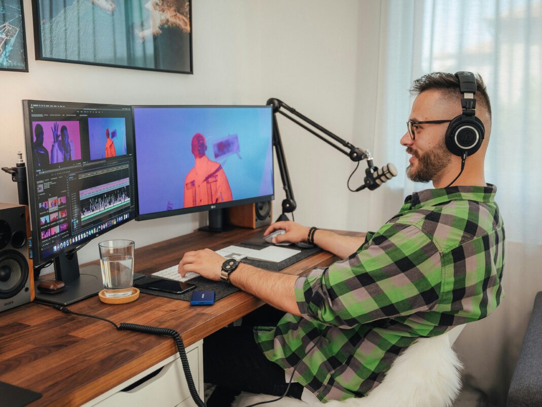 man-working-on-a-computer-screen-wearing-a-headset
