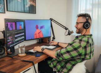 Optic vs Cable: Which Broadband Connection Is Best? man-working-on-a-computer-screen-wearing-a-headset