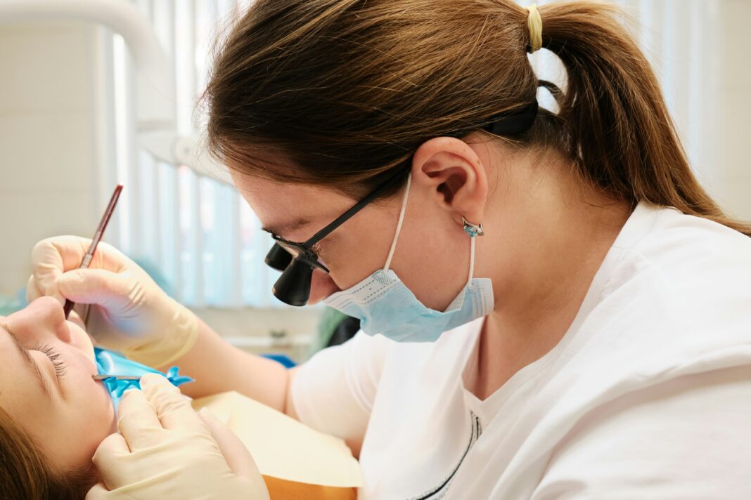 The Benefits of VoIP for UK Dental Clinics dentist-working-on-a-patient