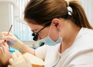 The Benefits of VoIP for UK Dental Clinics dentist-working-on-a-patient