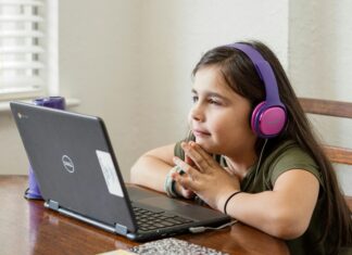 The Importance Of Reliable Broadband For Remote Learning girl-with-headphones-on-attending-class-on-her-laptop