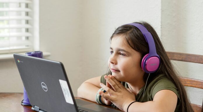 The Importance Of Reliable Broadband For Remote Learning girl-with-headphones-on-attending-class-on-her-laptop