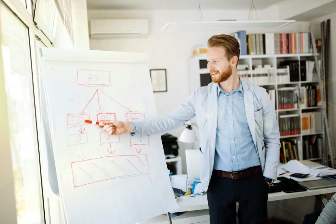 man-writing-on-a-white-board