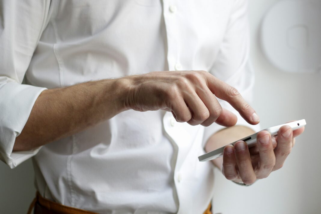 a-man-typing-on-his-phone
