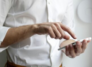 What Are the Benefits Of an eSIM? a-man-typing-on-his-phone