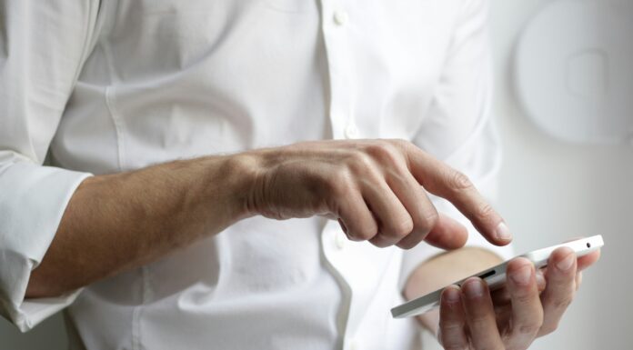 What Are the Benefits Of an eSIM? a-man-typing-on-his-phone