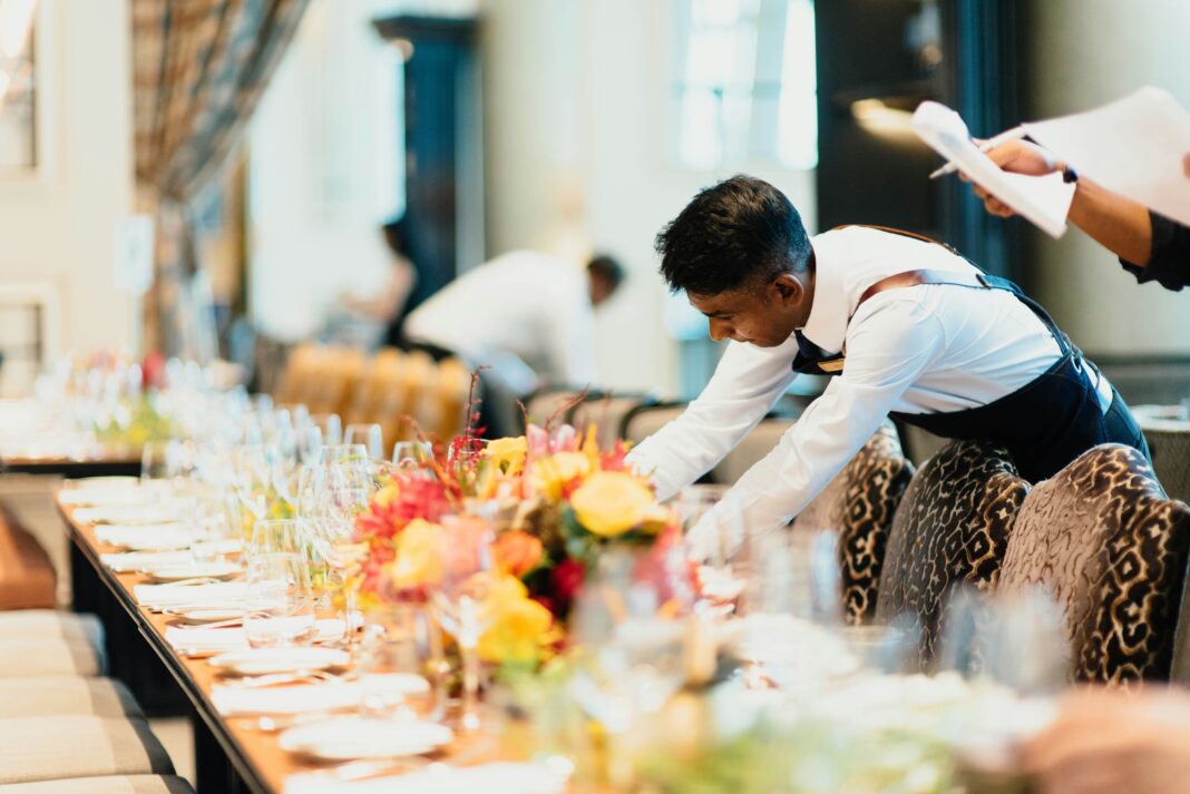 a-man-setting-a-table-in-a-restaurant