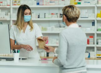 Why UK Pharmacies Are Switching to VoIP pharmacist-hading-medication-to-a-customer