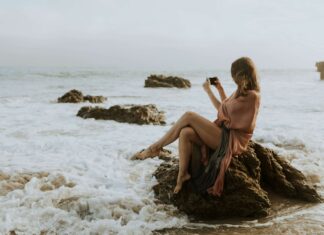 eSIMs vs International Roaming: Which Saves You More Money? woman using her esim to share holiday photos