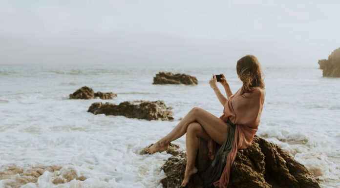 eSIMs vs International Roaming: Which Saves You More Money? woman using her esim to share holiday photos