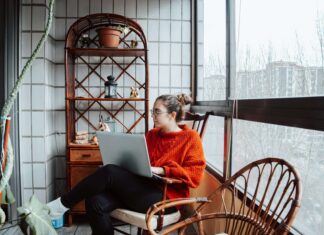 What Factors Affect Broadband Pricing in the UK? girl sitting enjoying home broadband