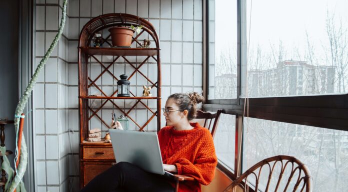 What Factors Affect Broadband Pricing in the UK? girl sitting enjoying home broadband