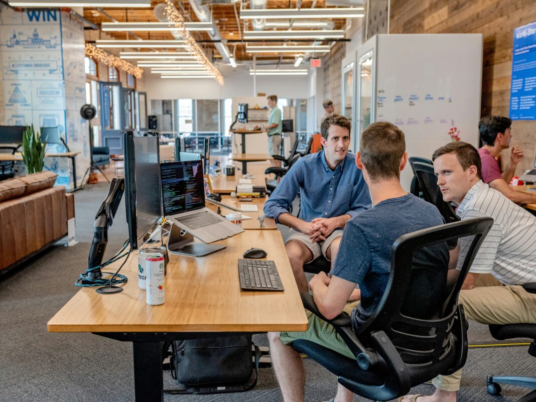 The Growing Adoption of VoIP in Emerging Markets shared-work-space-three-men-working-together