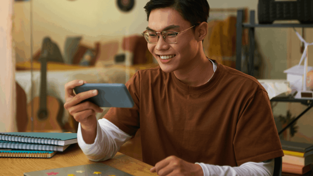man-looking-entertained-on-mobile-phone