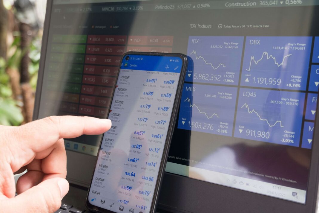 should-you-get-backup-broadband-line-for-your-business managing-stocks-phone-and-computer-screen