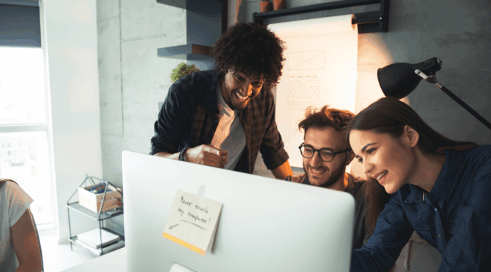 Budget-Friendly VoIP Setups For London Startups startup-employees-around-computer-screen-smiling