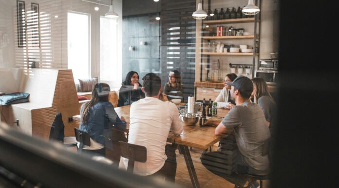 Using AI to Predict and Prevent VoIP System Downtime workplace-casual-meeting-in-office-kitchen
