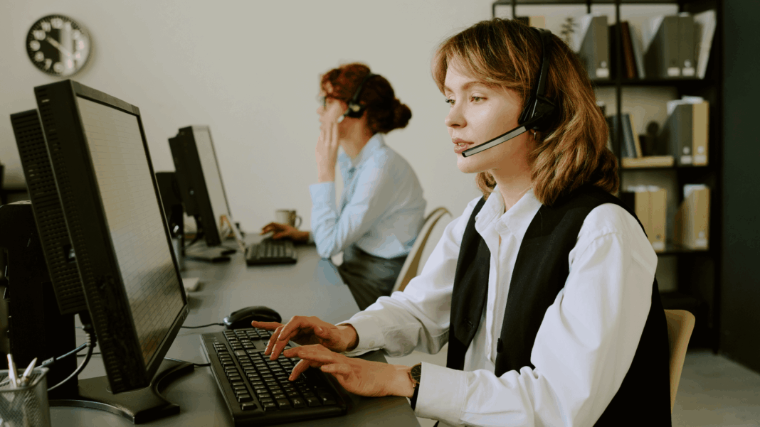 VoIP Cross-Border Compliance two-girls-working-in-office-with-headsets