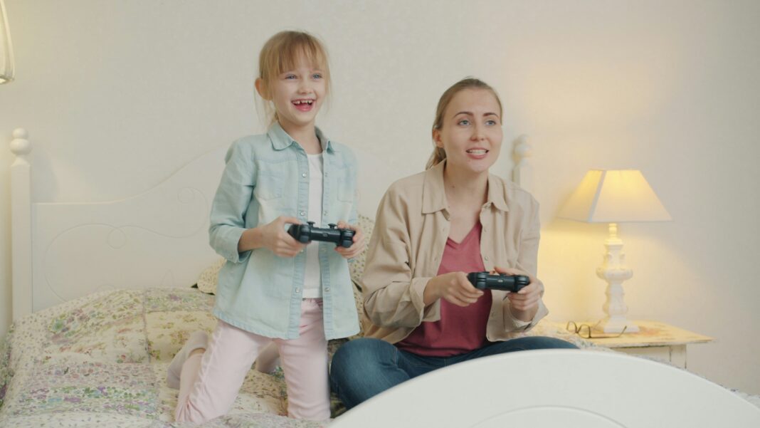 little girl and mum playing video games
