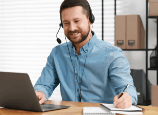 Experts Share: How VoIP Enables Multilingual, Real-Time Translations man-working-desk-writing-using-headset-through-voip