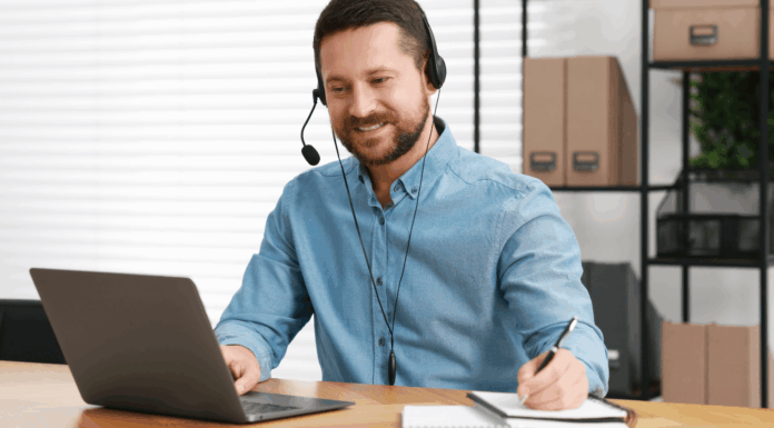 Experts Share: How VoIP Enables Multilingual, Real-Time Translations man-working-desk-writing-using-headset-through-voip