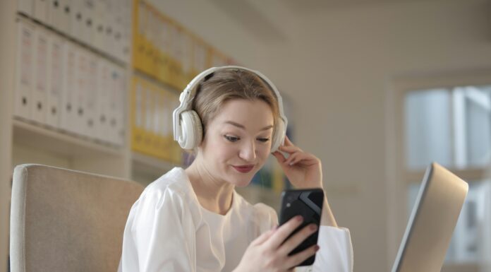 How Quantum Encryption Could Transform VoIP Security girl-sitting-at-desk-headphones-looking-at-phone