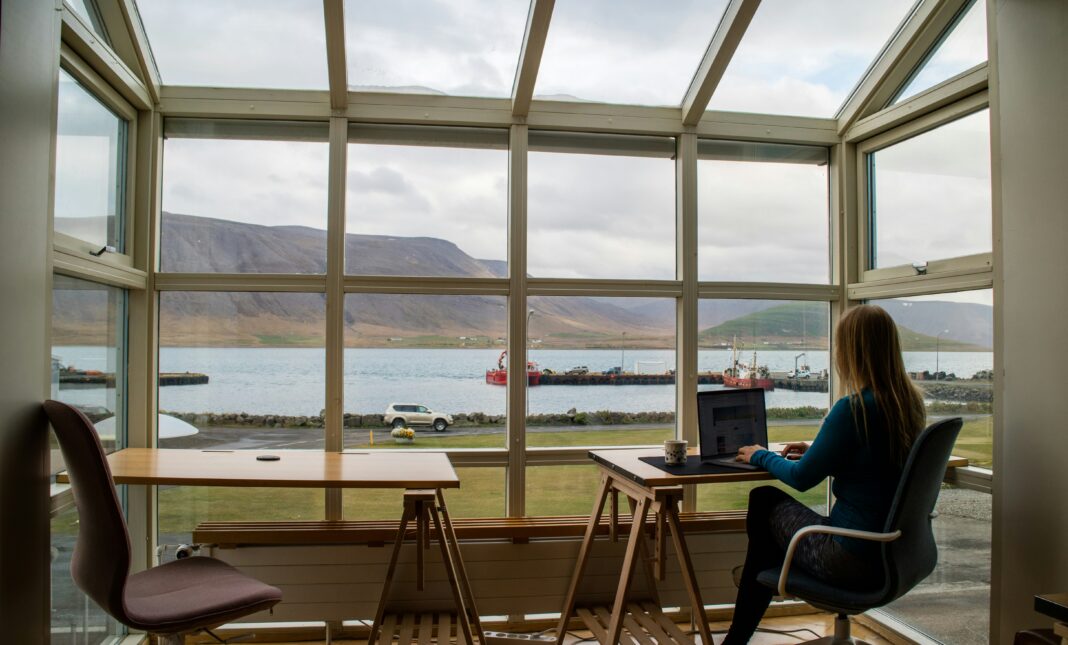 girl-working-from-office-large-windows-natural-view