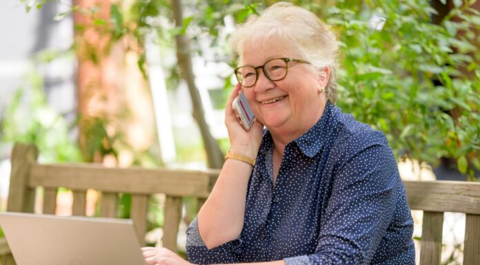 VoIP for Seniors: Simple, Affordable Calling Without Confusing Tech senior-woman-on-laptop-using-voip-phone-at-home