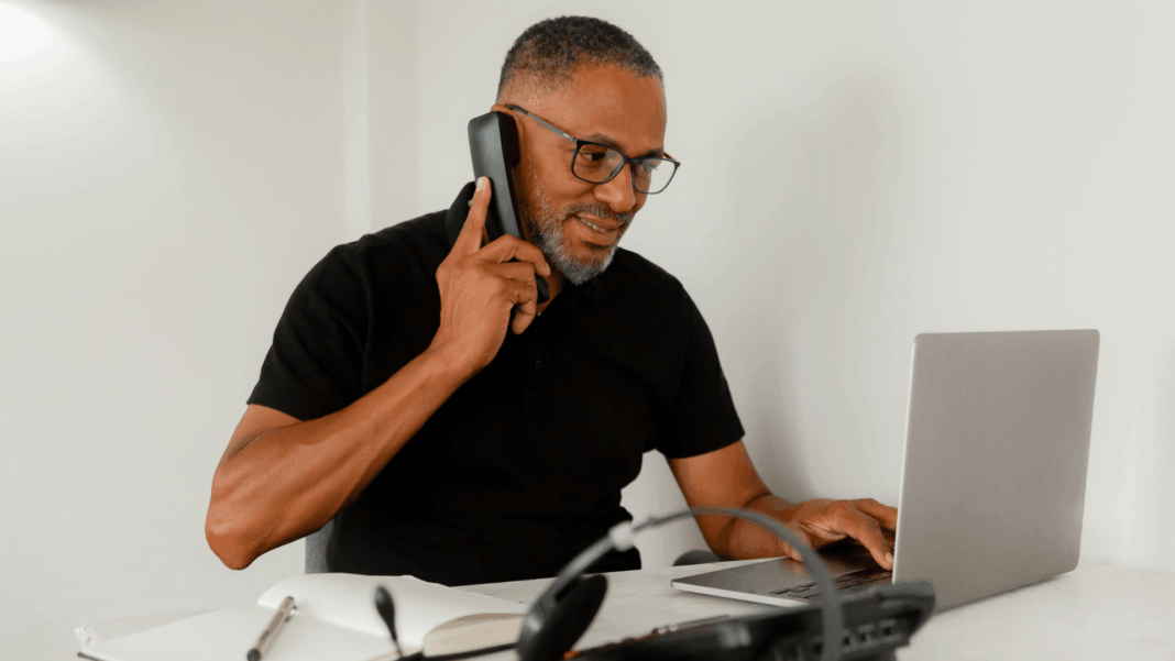 man-talking-on-voip-phone-using-laptop