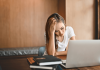 Why Does My Broadband Router Keep Disconnecting and How to Fix It? a-frustrated-woman-sitting-with-a-laptop-while-dealing-with-a-broadband-router-dropout