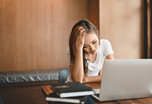 Why Does My Broadband Router Keep Disconnecting and How to Fix It? a-frustrated-woman-sitting-with-a-laptop-while-dealing-with-a-broadband-router-dropout