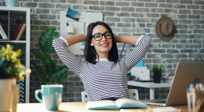 How Can VoIP Improve Employee Productivity? woman-working-in-bright-office-striped-shirt