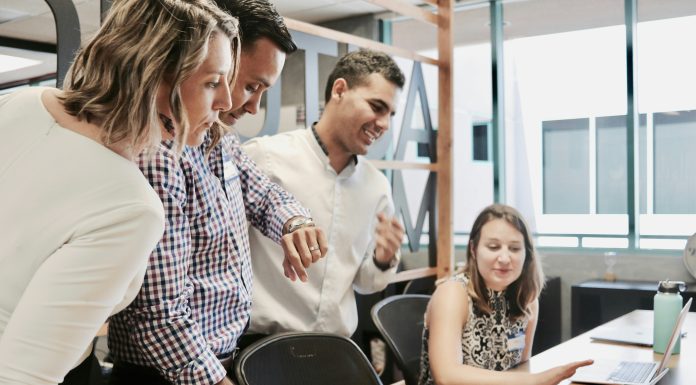 How Does VoIP Help Businesses Stay Organised? team-working-together-on-two-laptops